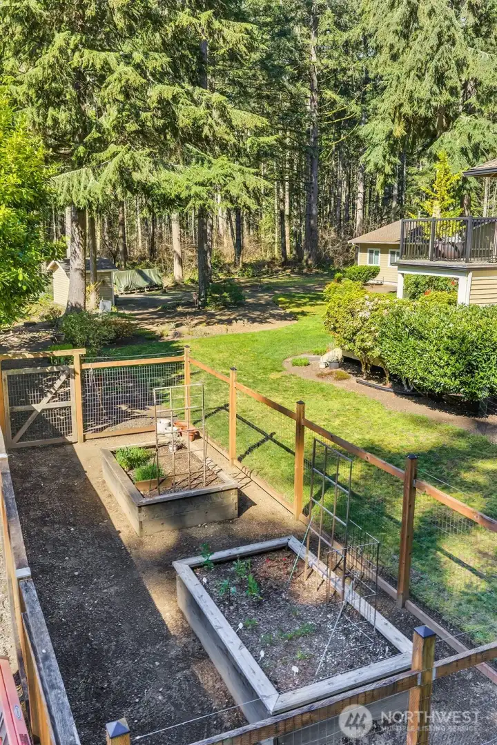 Raised beds for the avid gardener, fenced so deer can only enjoy looking at the harvest