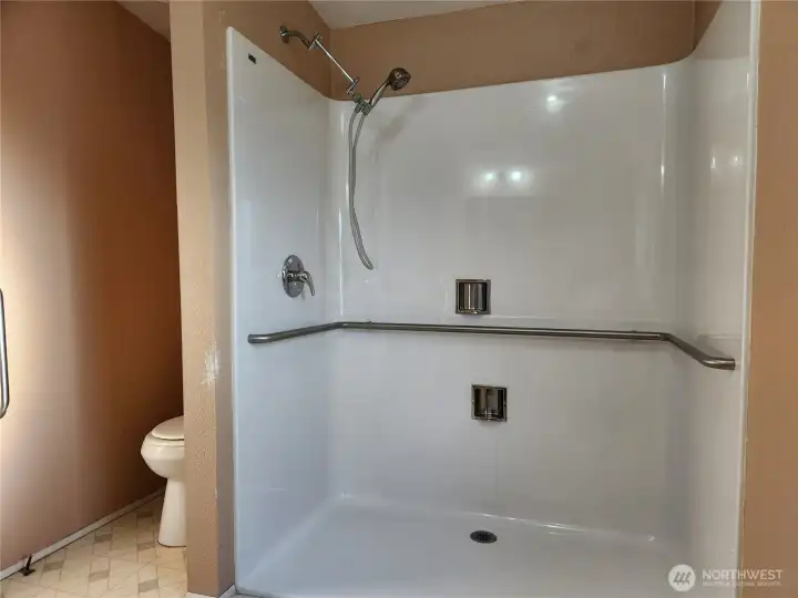 Primary bath has original shower and this added accessible shower.