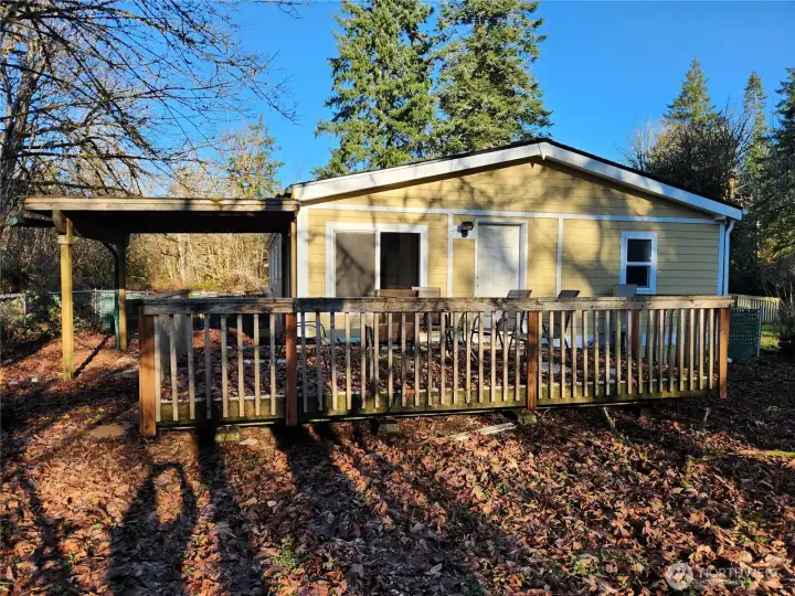 Deck and fenced yard off the utility room, plus covered patio out back.