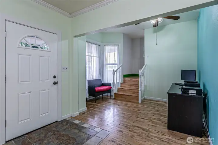 Main entry door to the left. nice entry area with main staircase going upstairs.  You'll appreciate the width of the stairs for moving items in the home.   Tall ceilings really open up rooms.