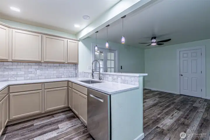 Second view of the kitchen & dining room.  Second main floor bathroom thru closed door is a 3/4 bath.  PLEASE NOTE There is also a second main floor bedroom off the rear of the kitchen not pictured.  It has a exterior door that might suit a business owner.