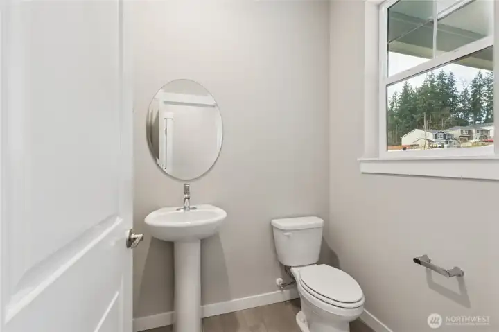 Main level powder room. Photos are for representational purposes only. Colors and finishes may differ.