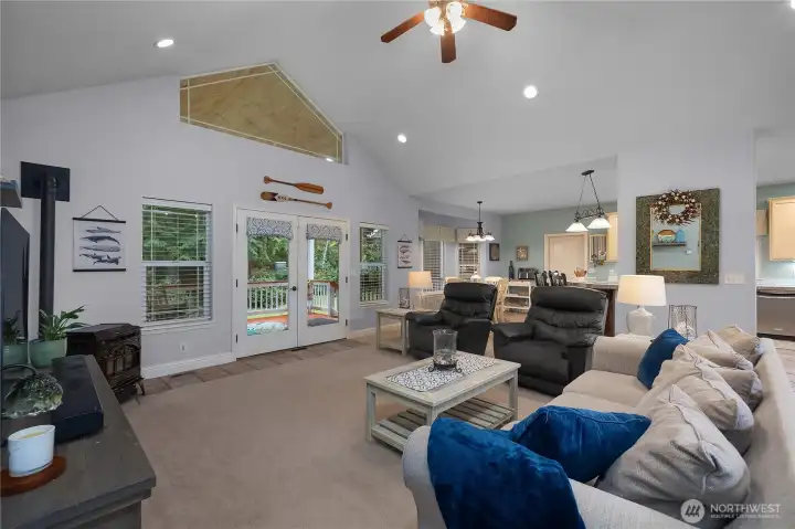 Great room with vaulted ceiling and french doors that lead to the back deck. Pellet stove.
