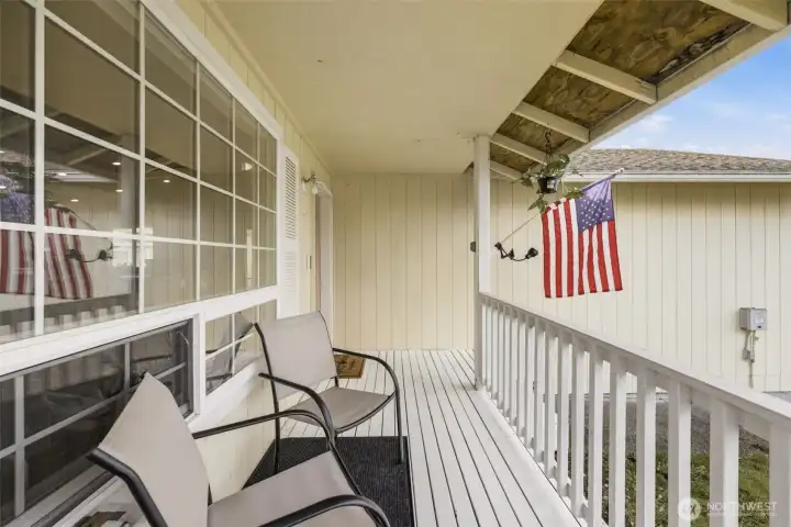 Inviting west-facing covered front porch—an ideal spot to relax and unwind while enjoying afternoon sun and evening sunsets.