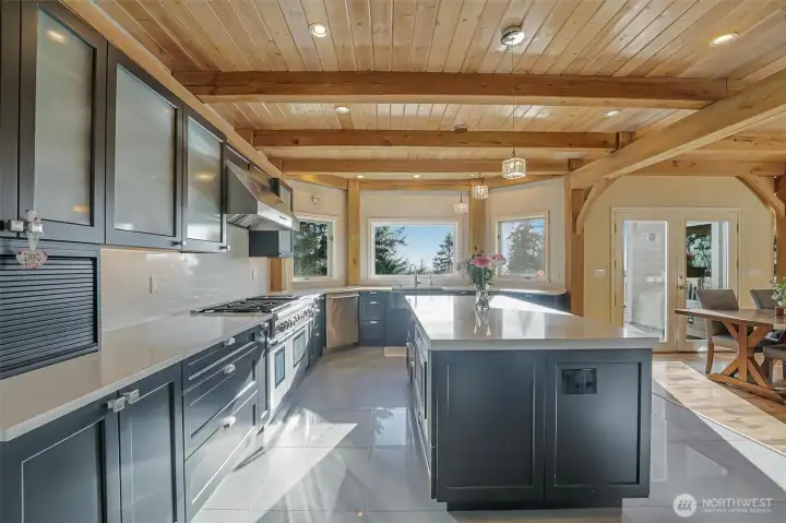 A kitchen that dreams are made of, including a Sub-Zero refrigerator and 8+ burner Thermador range.