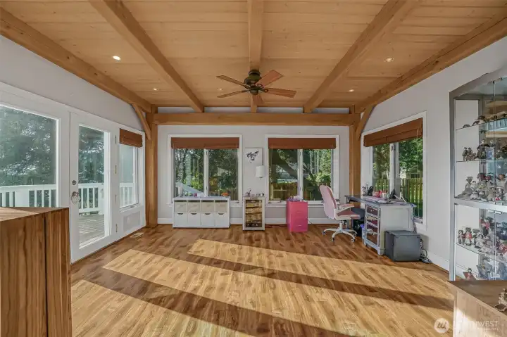 On the other side of the Great room is the sun room; a perfect library, art studio or additional office space.