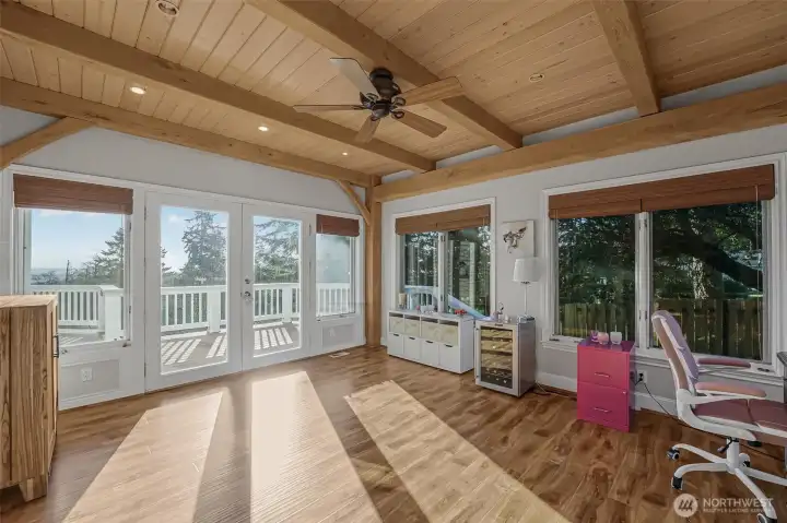 The sun room has its own access to the deck and has lots of windows that let in the incredible views.