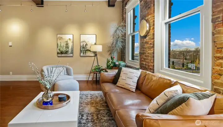 Penthouse View Lounge catching late light across Alaskan Way and the waterfront promenade