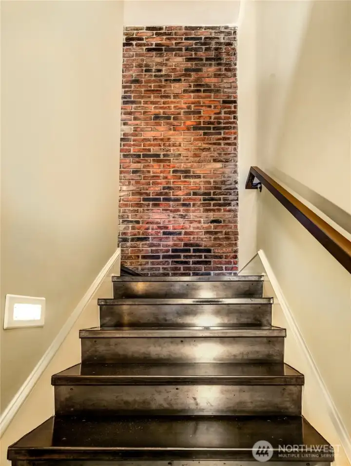 Stair drawing you upward between Entertaining and Private Levels without breaking the flow