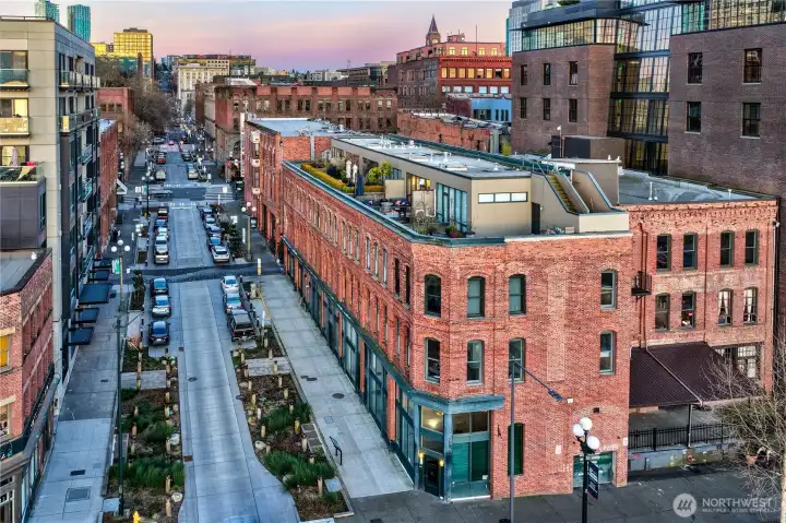 Main Street corridor just outside, leading east into Pioneer Square’s core in under a block