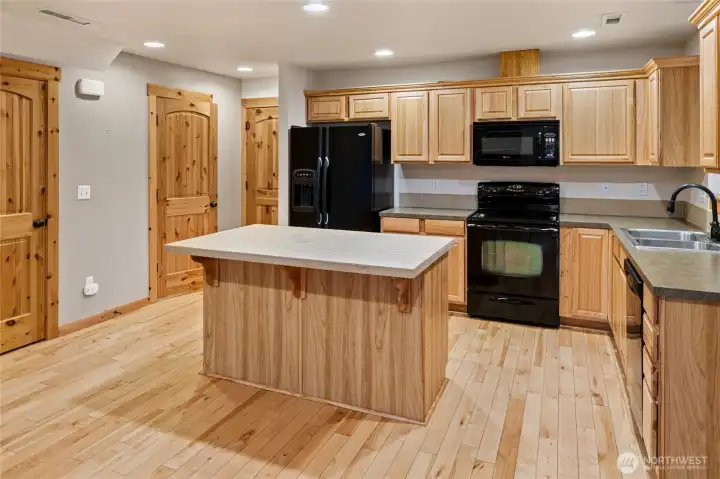 Well-appointed kitchen featuring ample cabinetry and counter space.