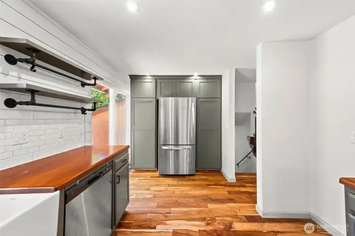 Kitchen with custom cabinetry around refrigerator
