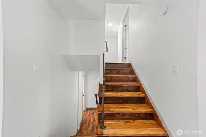 Stairs - 2 bedrooms, hall bath and Primary Suite upstairs. Den/Office with half bath, Laundry and Garage Access downstairs