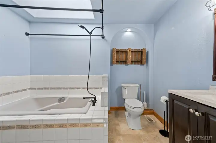 Upstairs Hall Bath with soaking tub and skylight