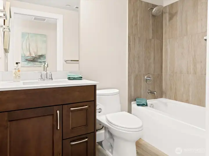 Main bath, near the 2nd bedroom, has a tub-shower combo with a full tile surround. Main bath, near the 2nd bedroom, has a tub-shower combo with a full tile surround.