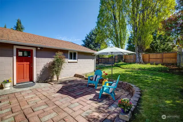 A spacious backyard with a brick patio is perfect for entertaining all summer long!