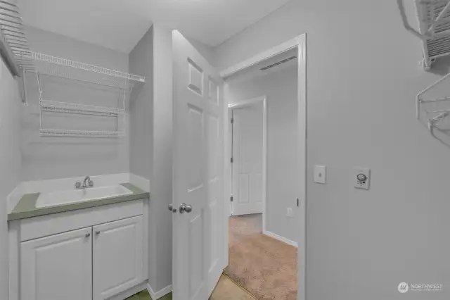 Laundry room features a sink...