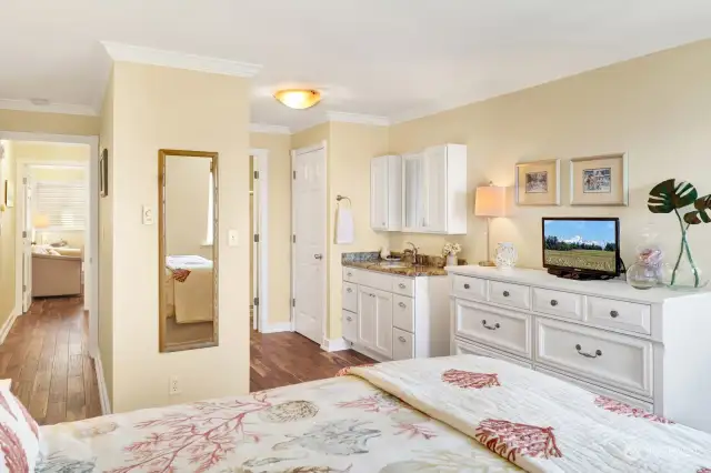 Nicely sized primary with sink vanity to get ready in the morning, closet is opposite.