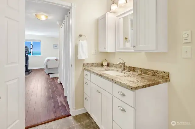 Bathroom has door into primary bedroom, and hallway separates  the 2nd bedroom.