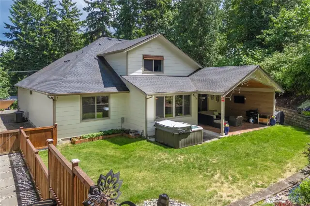 Garden, relax, and soak up the sunshine from this stunning backyard