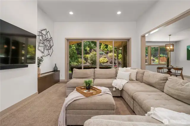 The living room has grand sliders that open to the picturesque backyard