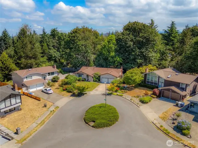 This home is nestled quietly at the back of a cul-de-sac that has a center island.