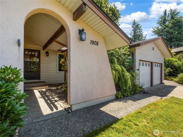 The structure of the home creates a lovely v, tranquil vestibule before you reach the front door.