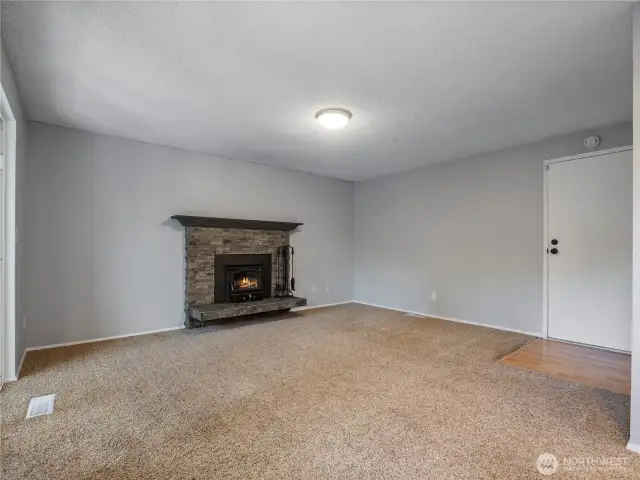 The comfortable family room is open to the kitchen and features a new wood stove insert with blower that creates bone-warming heat for cozy winter nights.