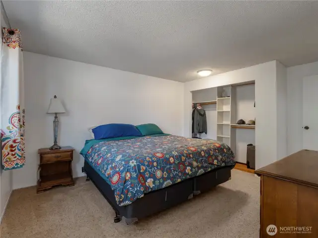 The primary suite is very spacious with side-yard views.