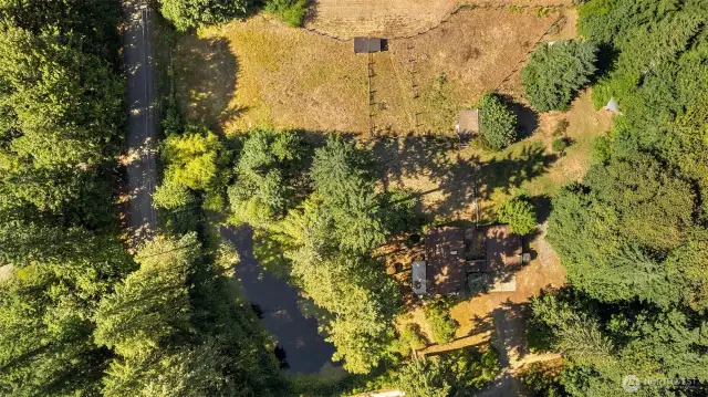 Fields on the N side of the property w/ house/gar on the S side