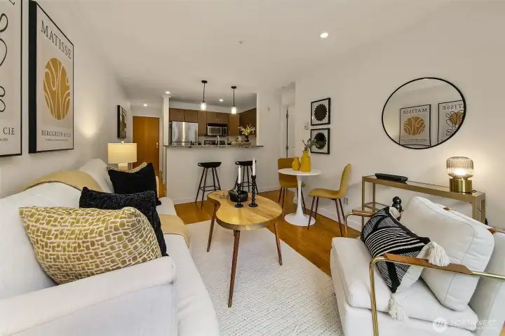 Efficient and flexible open living area. Space for a cozing living room set up, dining and office. View towards kitchen and entry with large closet.