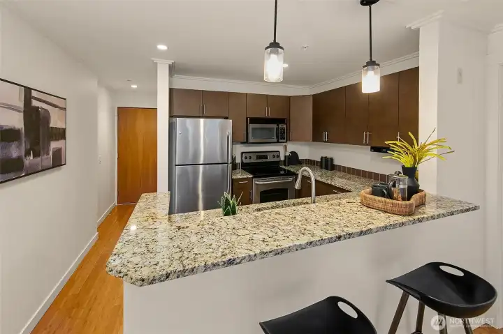 View of the kitchen towards the entry. Bamboo floors run through from the entry with a large closet to the bedroom.