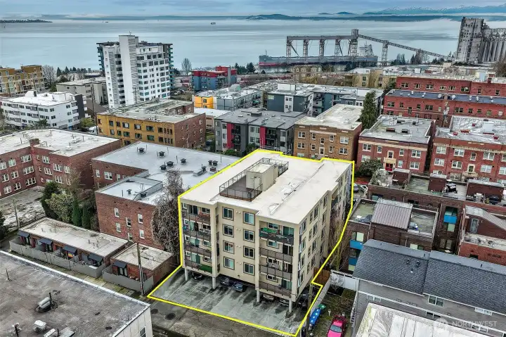 View West of the building. This unit has a secure parking space in the garage. Lovely views from the rootop deck towards the Olympic Mts.