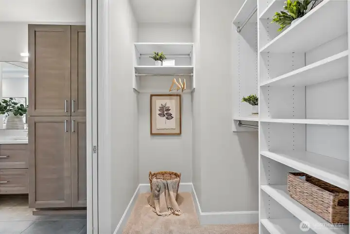 Primary Walk-in closet - left side nook, carpeted flooring throughout closet.