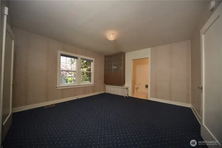 Main level primary bedroom with half bath