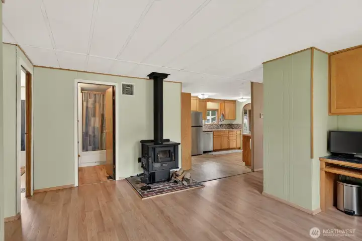 Inviting great room featuring a cozy wood stove and open, comfortable layout.