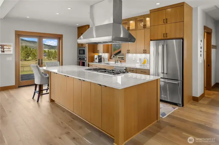 Kitchen featuring French doors that open to the backyard patio, creating a seamless flow between indoor living and outdoor entertaining space.