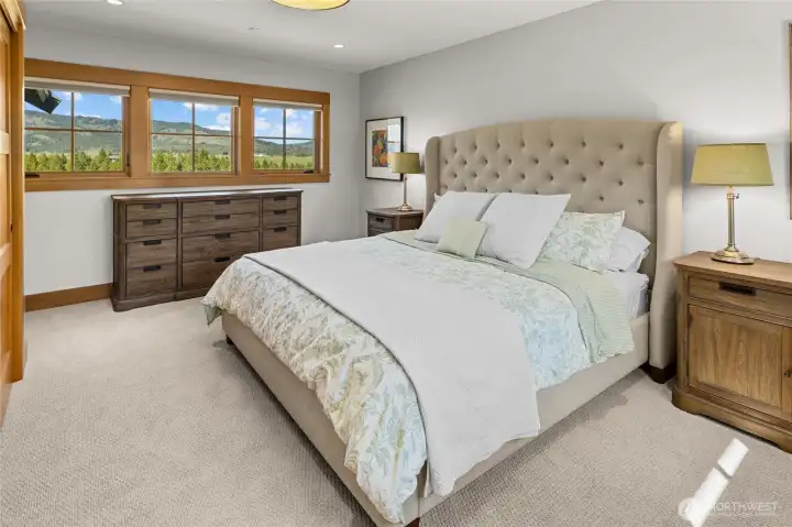 Upstairs guest bedroom featuring a beautiful view and a comfortable, welcoming setting.