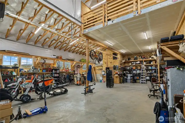 Shop offers ample space for vehicles and recreational toys, and includes a convenient half bath.