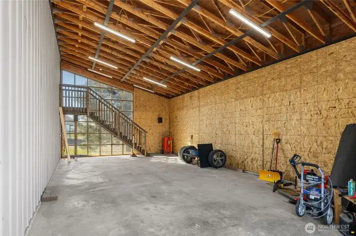 Carport offering versatile use, with rear stairs providing access to the bonus room.