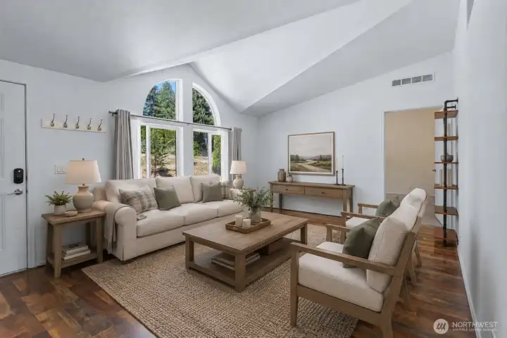 The open-concept living area welcomes you with soaring vaulted ceilings, abundant natural light, and a spacious layout designed for both everyday living and entertaining. [Photo is virtually staged]