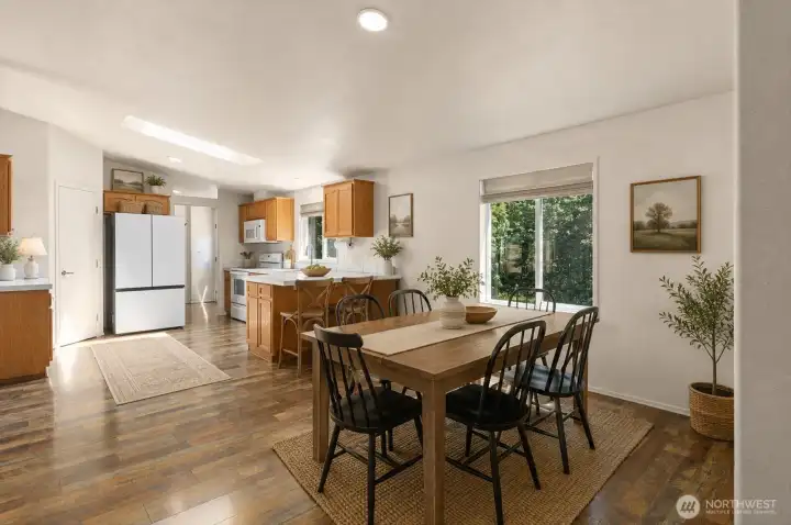 The seamless flow between the living room, dining area, and kitchen enhances both functionality and livability. [Photo is virtually staged]