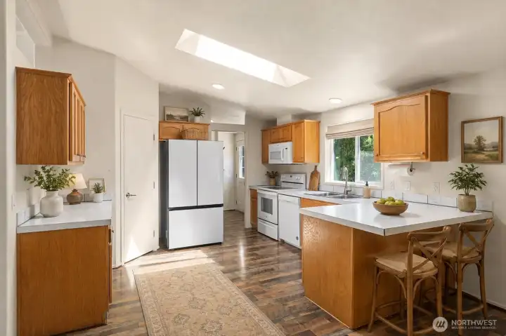 Designed with both form and function in mind, the chef-inspired kitchen offers abundant counter space, ample cabinetry, and a spacious walk-in pantry. The open layout allows the cook to stay connected to family and guests while preparing meals and entertaining. [Photo is virtually staged]