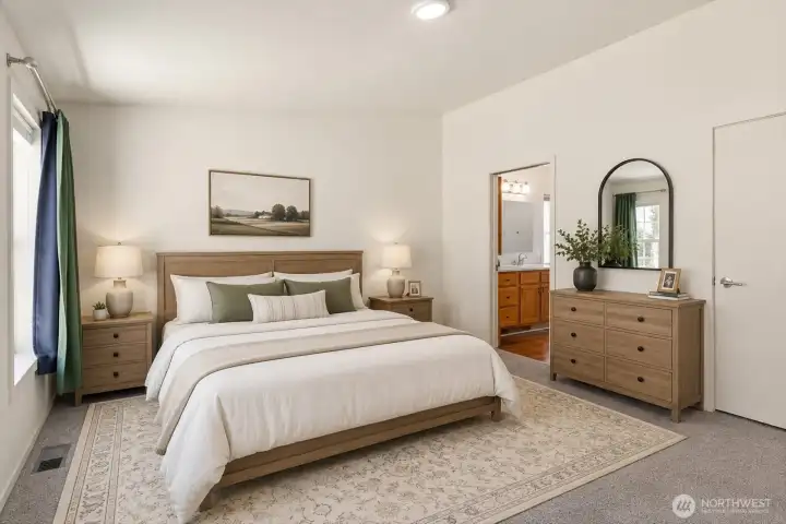 Privately situated away from the secondary living spaces, the primary suite serves as a peaceful retreat at the end of the day. The spacious bedroom offers room for a full furniture set while maintaining an open and relaxing feel. [Photo is virtually staged]