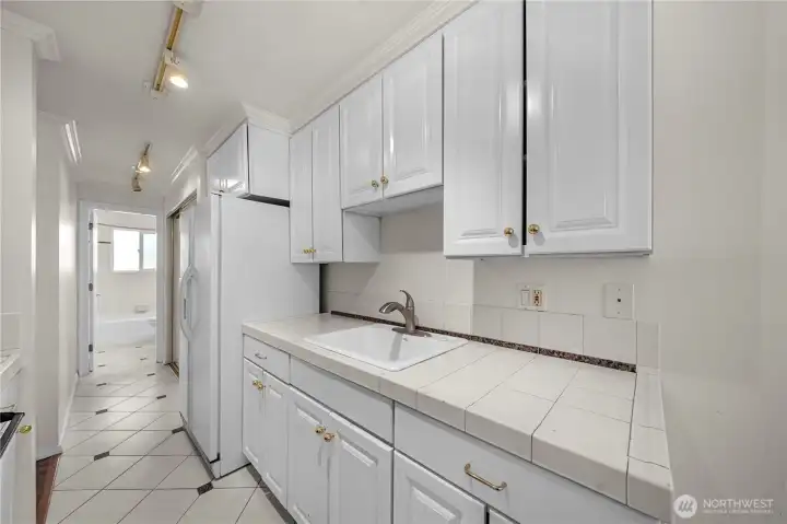 Update kitchens with tile flooring & newer white cabinets