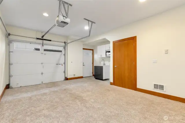 Insulated garage w/ separate entrance, kitchenette + laundry hook up.