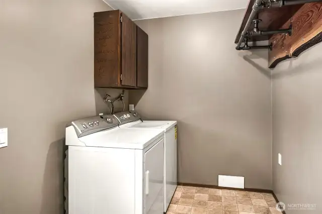 Huge laundry/mudroom with door to backyard and attached garage.