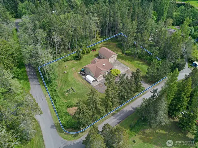 Located just beyond the limits of the Town of Friday Harbor on a very large, level, sunny lot this three bedroom single level home has an attached two car garage and a detached shop with oversized door