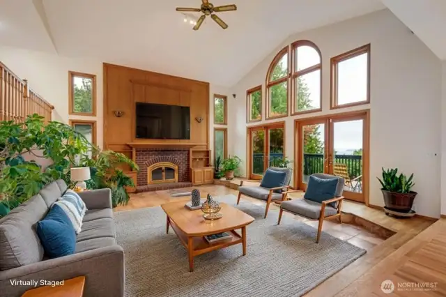 Virtually staged great room with gorgeous wood work and floor to ceiling windows to enjoy the breathtaking views!