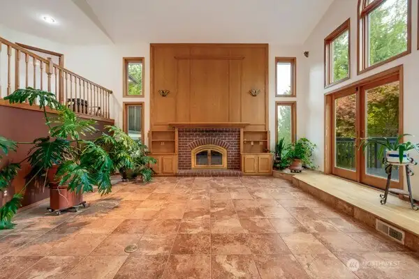 Elegant wood burning fireplace with stunning built-ins.